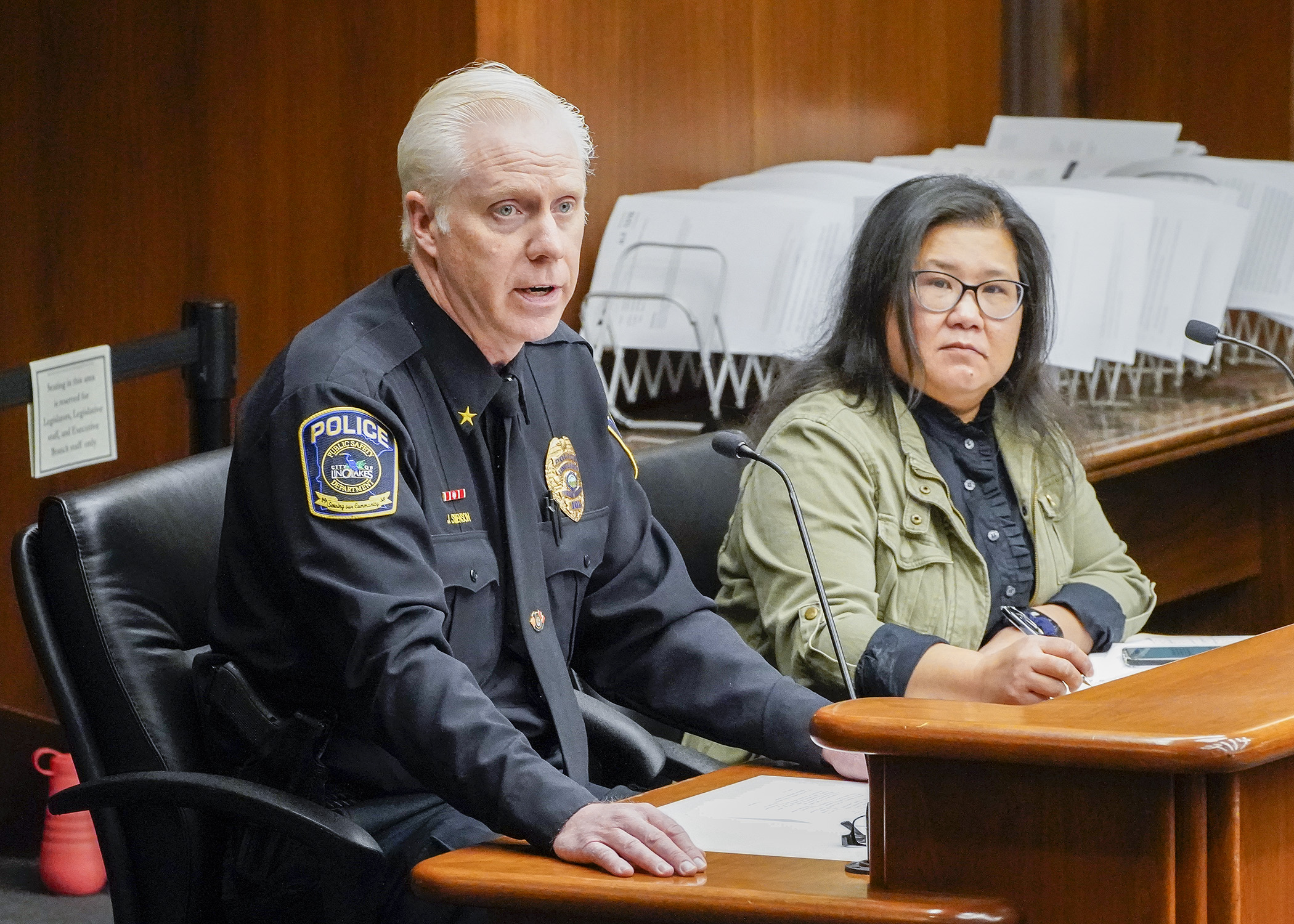 John Swenson, public safety director for Lino Lakes, testifies before the House Public Safety Finance and Policy Committee March 9 in support of HF1234, sponsored by Rep. Kaohly Vang Her, right. (Photo by Andrew VonBank) 